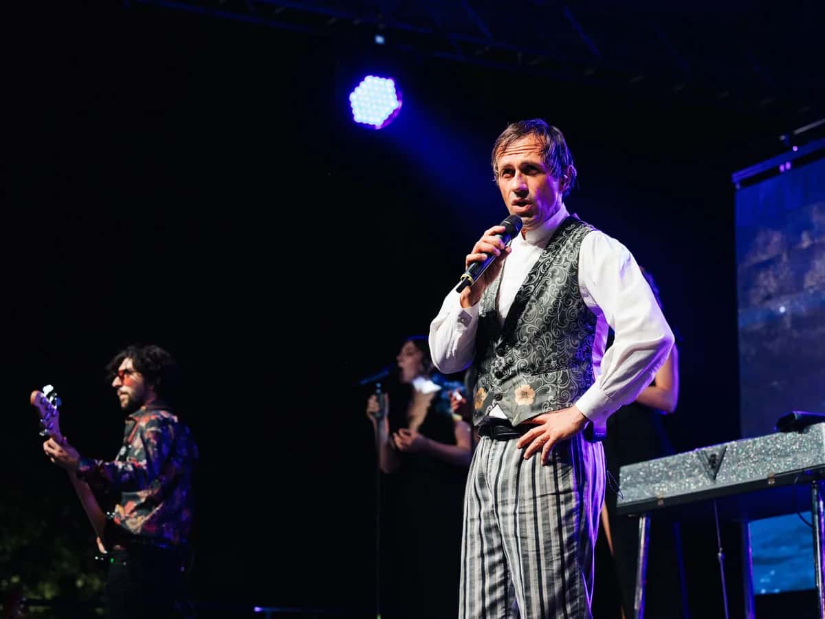 Celentano Tribute Show singer on stage in a waistcoat