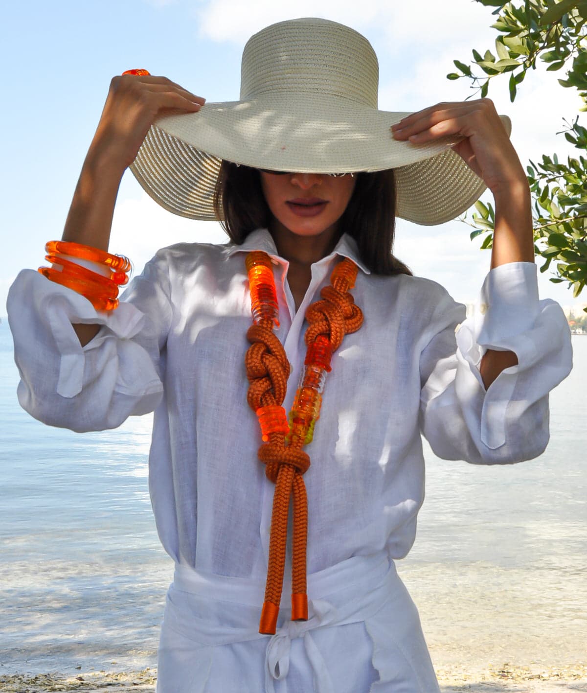Chofa Jewelry lucite pieces styled in a sunlit Miami beach look